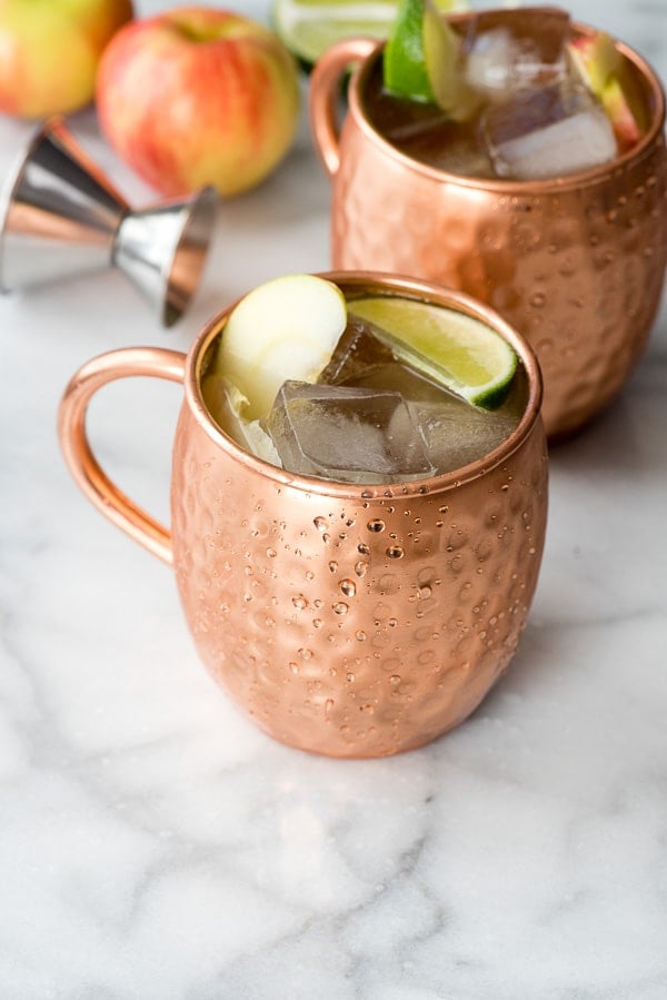 Apple Cider Moscow Mules. Vodka with lime wedges