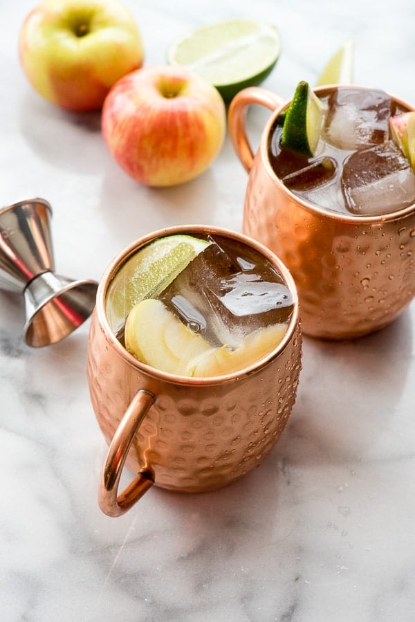 Apple Cider Moscow Mules with jigger and apples