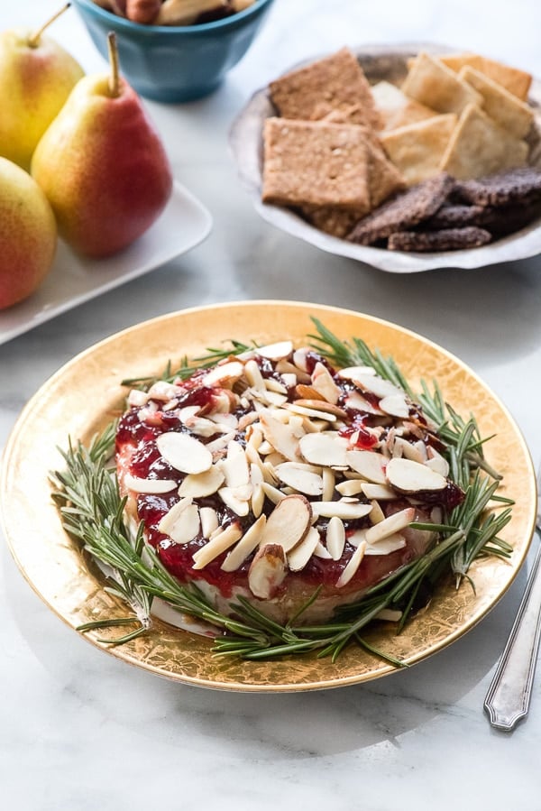Baked Brie with Cherry Preseves and Almonds on a plate