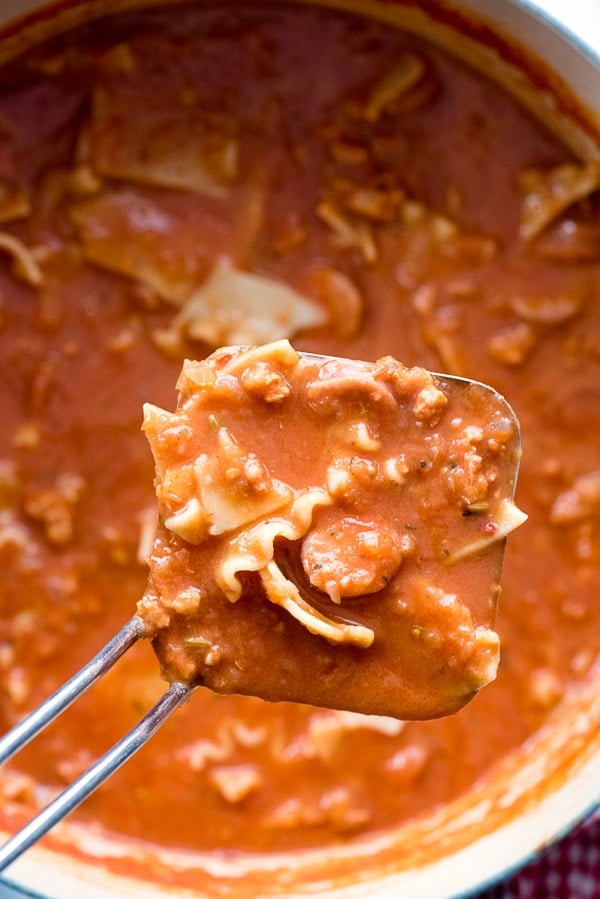 A close up of a Lasagna soup in ladle 
