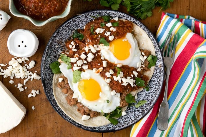 Huevos Rancheros. Fresh, spicy sauce, pinto beans, fried eggs and Mexican cheese on corn tortillas make this the perfect start to the day! BoulderLocavore.com