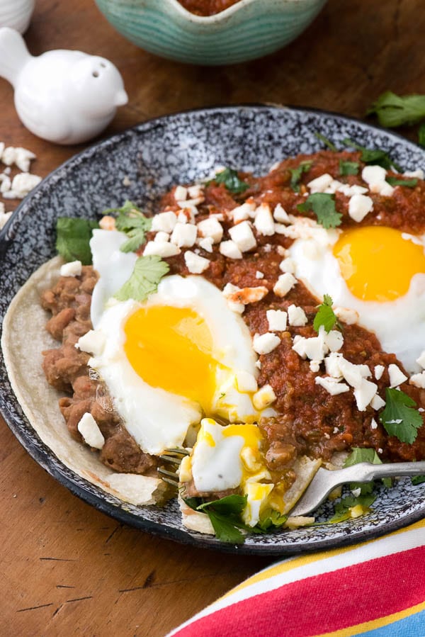 Huevos Rancheros. Fresh, spicy sauce, pinto beans, fried eggs and Mexican cheese on corn tortillas make this the perfect start to the day! BoulderLocavore.com