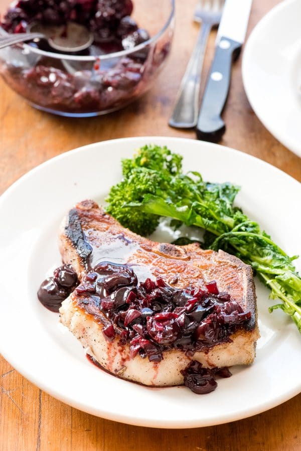 Pan-fried Brined Pork Loin Chops with Cherry-Port Sauce on white plate