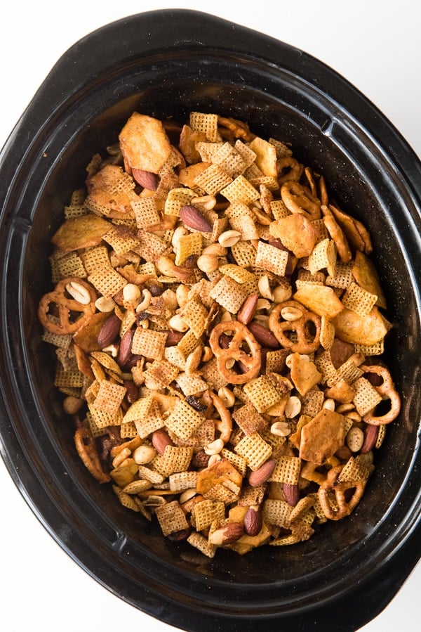 Slow cooker of homemade Chex Party Mix. 