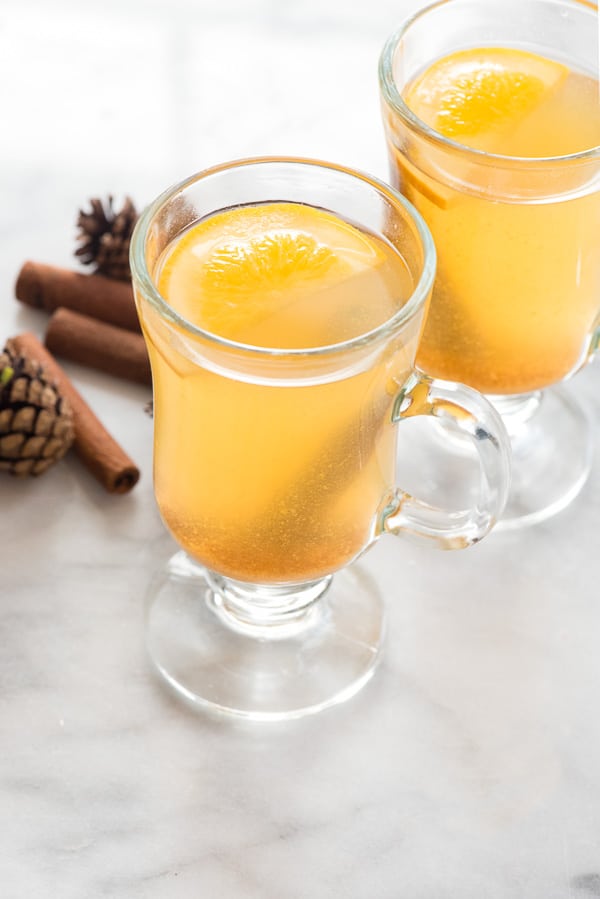 Slow Cooker Mulled Apple Cider in glass mugs with orange slices