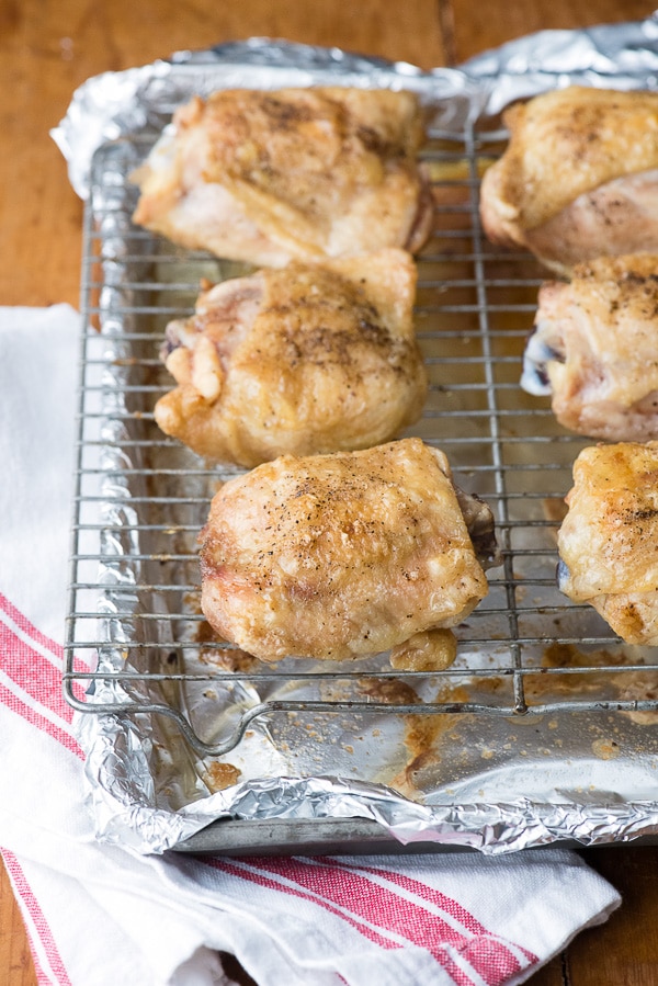 Salt and Pepper Roasted Chicken Thighs with crispy skin on cooking rack