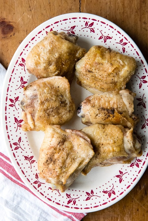 Salt and Pepper Roasted Chicken Thighs on a vintage platter
