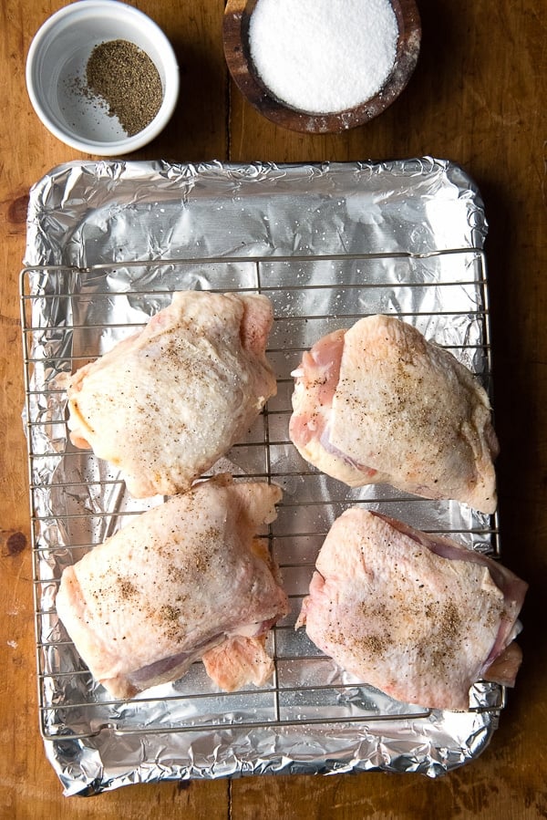 Salt and Pepper Roasted Chicken Thighs before cooking on a cooking rack