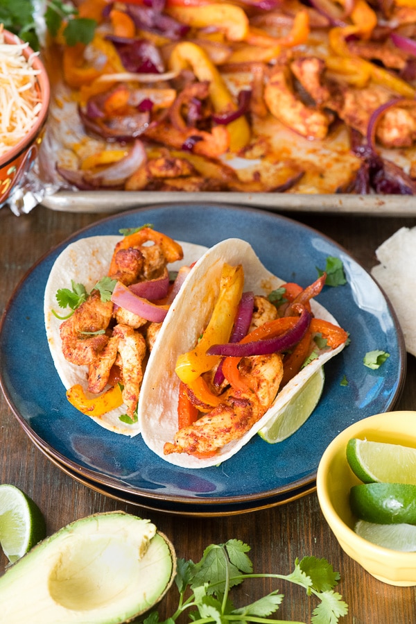 Plate of Sheet Pan Chicken Fajitas with sheet pan in background