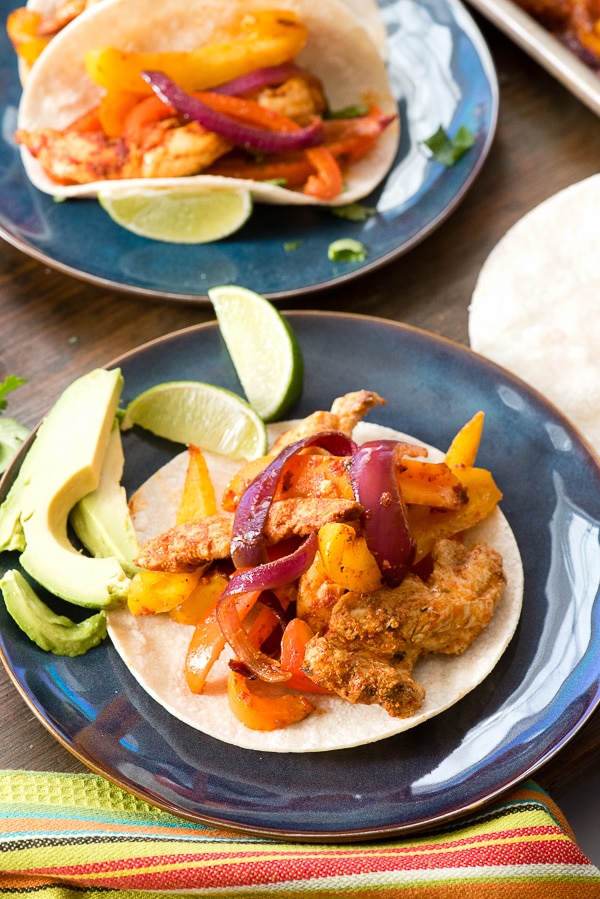 Corn tortilla with chicken fajita and lime wedges