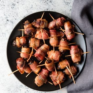 black plate of Devils on Horseback appetizer