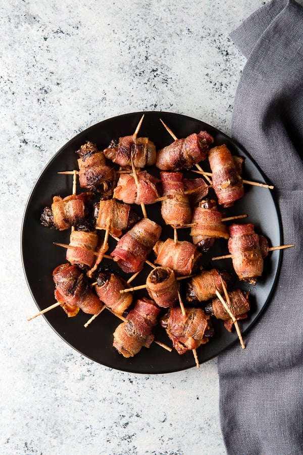 black plate of Devils on Horseback appetizer 