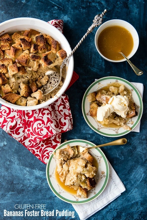 White baking dish of Bananas Foster bread pudding with servings in separate plates with recipe title on image