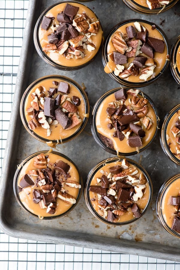 Overhead view of caramel with chocolate chunks on brownies