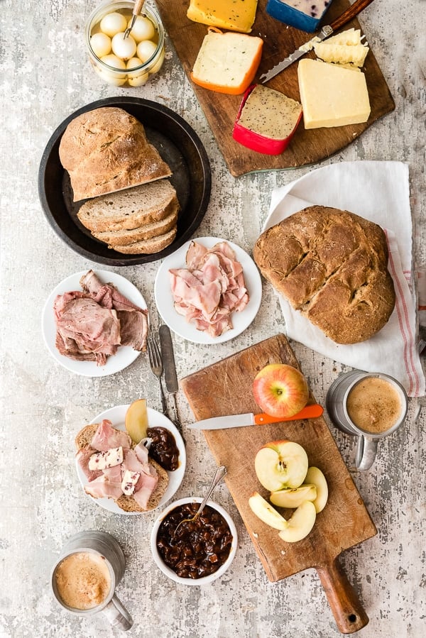 Ploughman\'s Lunch. A simple, rustic British meal of crusty bread, meats, cheese, pickled foods and ale