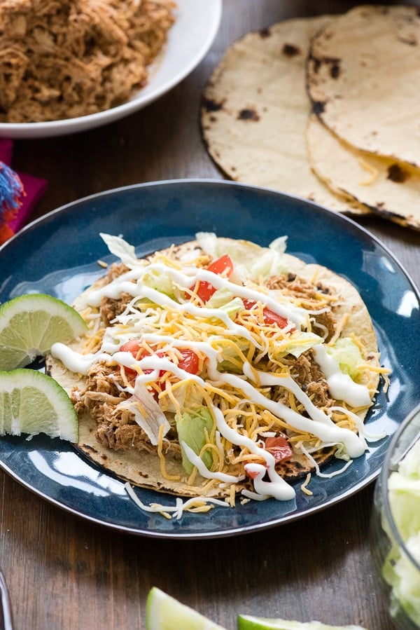 Slow Cooker Mexican Chicken Taco Meat on corn tortillas
