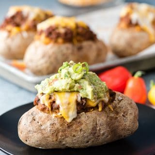 Taco-Stuffed Baked Potatoes. Spicy, ground beef mixed with cheesy sour cream mashed potatoes for a taco-inspired comfort food main dish recipe! Gluten-free.- BoulderLocavore.com