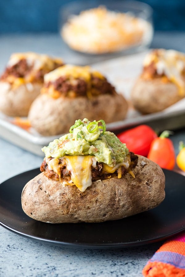Taco-Stuffed Baked Potatoes. Spicy, ground beef mixed with cheesy sour cream mashed potatoes for a taco-inspired comfort food main dish recipe! Gluten-free.- BoulderLocavore.com