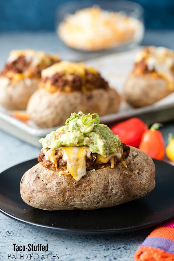 Taco-Stuffed Baked Potatoes. Spicy, ground beef mixed with cheesy sour cream mashed potatoes 