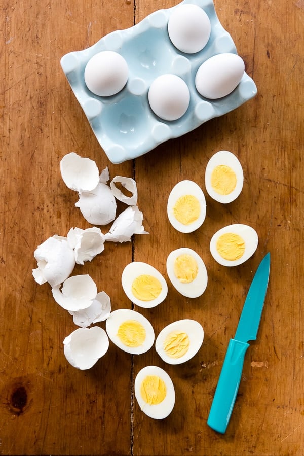 sliced Instant Pot hard boiled eggs on a wood cutting board