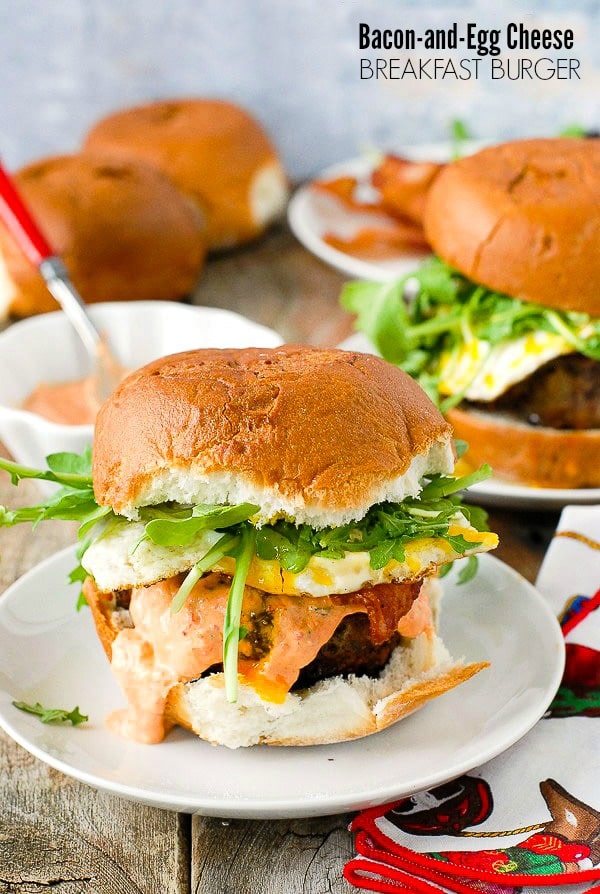 Juicy, grilled Bacon and Egg Cheese Breakfast Burger with arugula on a white plate BoulderLocavore.com