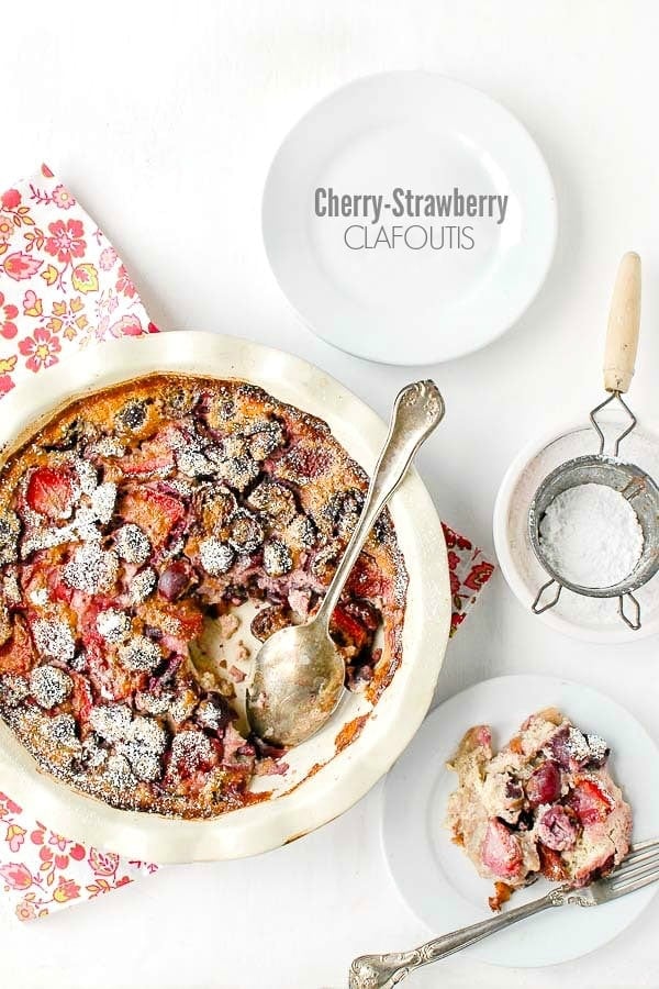 Cherry Strawberry Clafoutis in a pie pan with a single serving