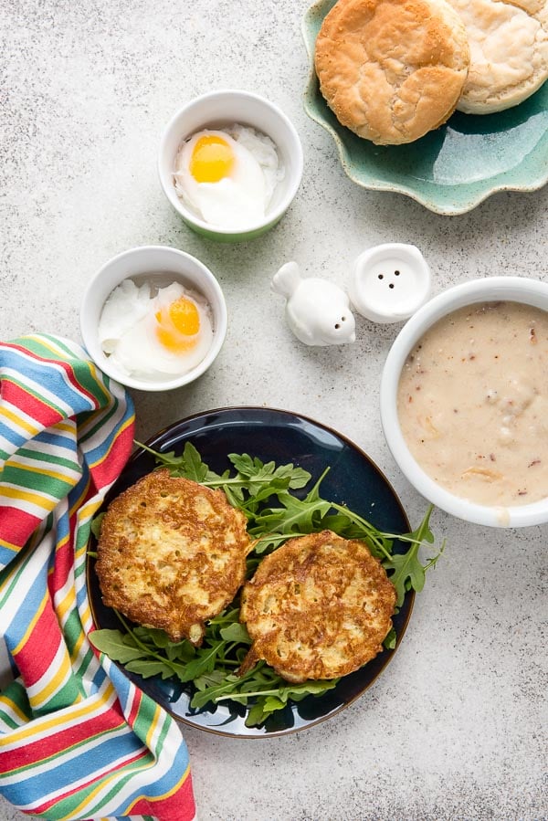 Golden-brown English Muffin French Toast (gluten-free) with arugula, bacon-maple gravy, poached eggs