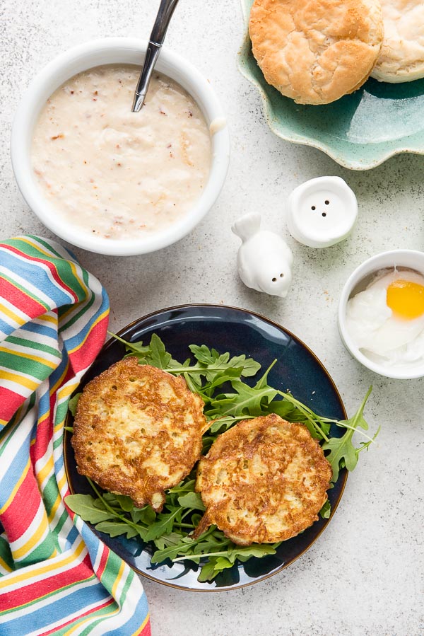 Savory gluten-free English Muffin French toast with salty, sweet Bacon-Maple Gravy on a bed of arugula