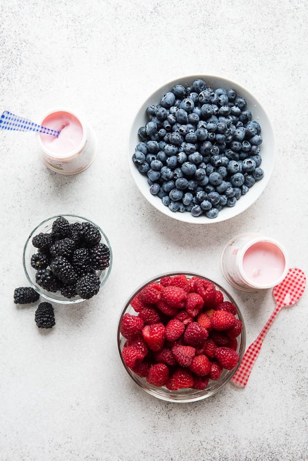 White bowls of fresh blueberries, raspberries and blackberries for gluten-free Overnight Lemon Muffin Breakfast Trifles