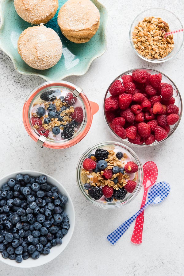 Overnight Lemon Muffin Breakfast Trifles with bowls of fresh raspberries and blueberries