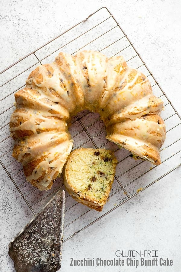 Gluten-Free Zucchini Chocolate Chip Bundt Cake with vintage cooling rack and ornate etched silver cake server