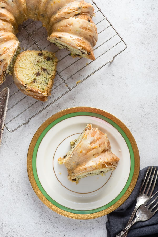 Single slice of freshly baked Gluten-Free Zucchini Chocolate Chip Bundt Cake with orange glaze 