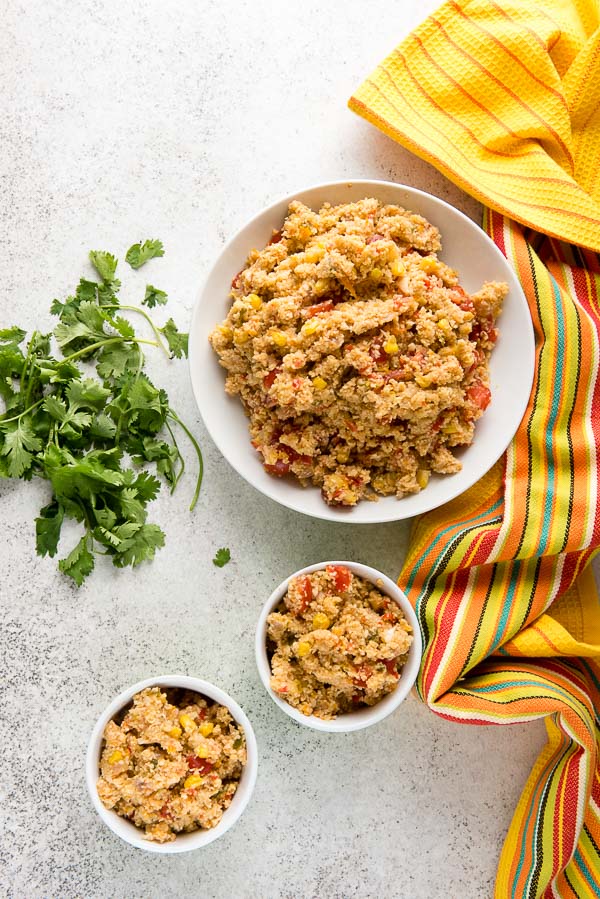 Three bowls of spicy Mexican Fiesta Cauliflower Rice with fresh cilantro 