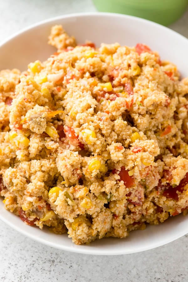 Close-up bowl of Mexican Fiesta Cauliflower Rice with red pepper, corn, jalapeno, onion 