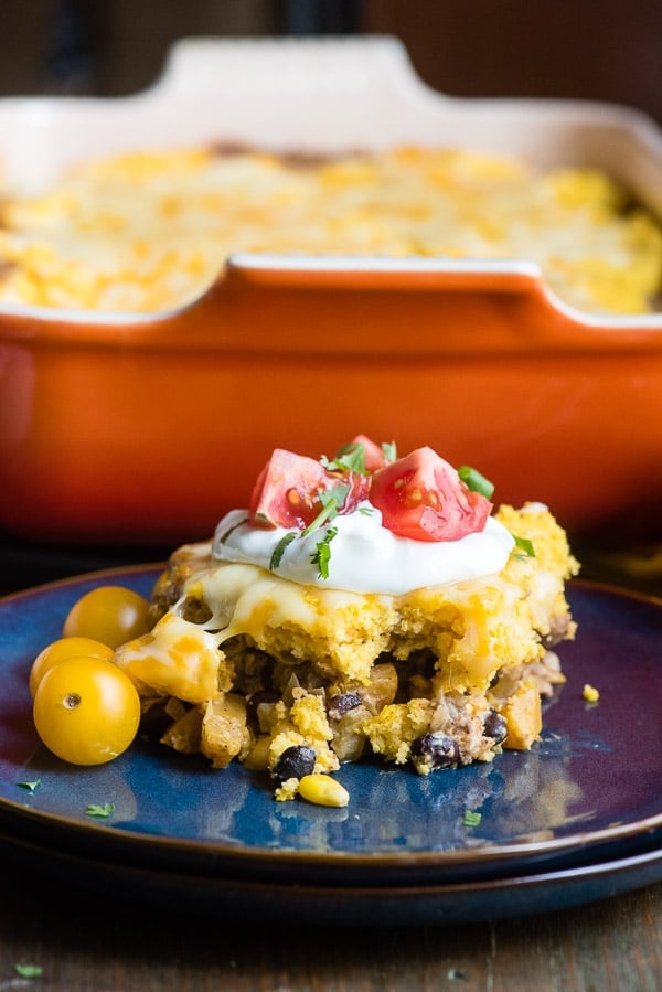 Single serving gluten-free Black Bean Pumpkin Tamale Pie on a blue ceramic plate