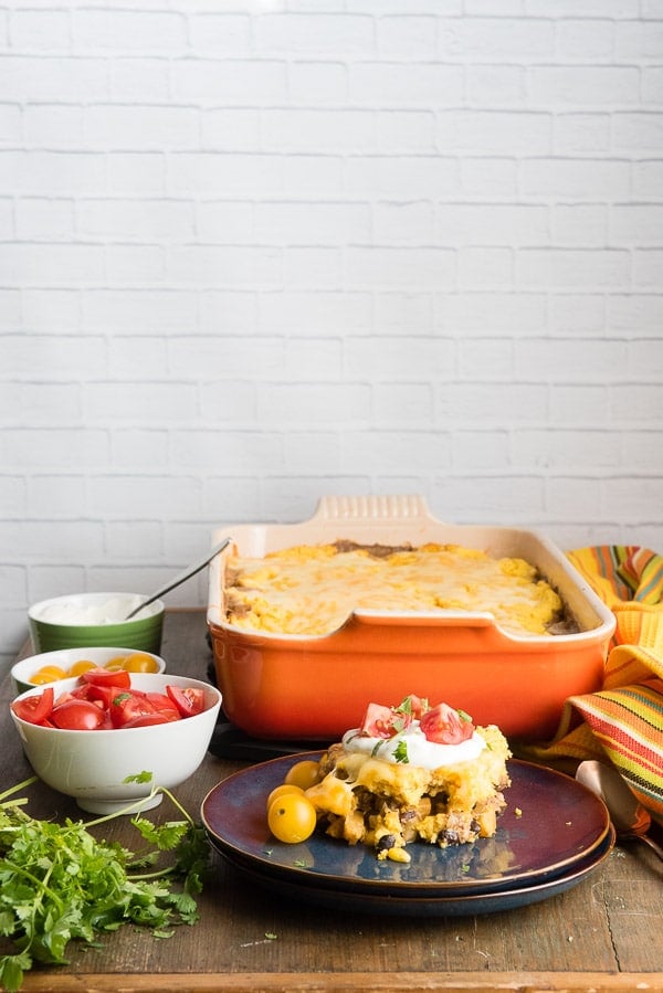 Black Bean Pumpkin Tamale Pie with sour cream, chopped tomatoes, yellow cherry tomatoes 