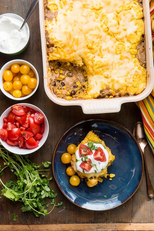 Single serving Black Bean Pumpkin Tamale Pie with sour cream, fresh tomatoes and fresh cilantro 