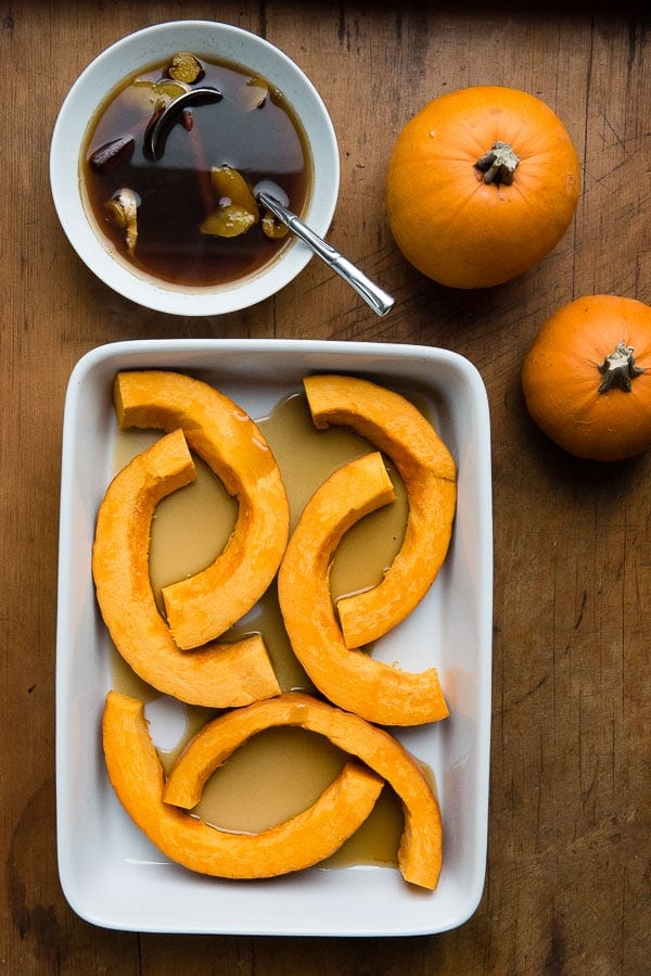 Sliced fresh pumpkin, mini pumpkins and caramel cinnamon ginger sauce for Caramelized Roasted Pumpkin