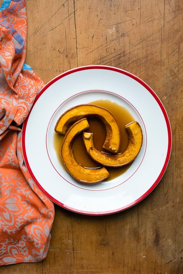 Three slices of Caramelized Roasted Pumpkin in caramel sauce, in a large white bowl