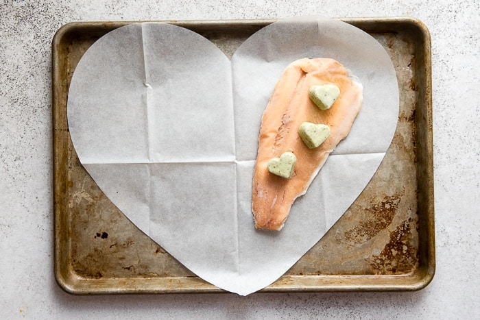 Rainbow Trout with Salsa Verde Sauce on parchment paper