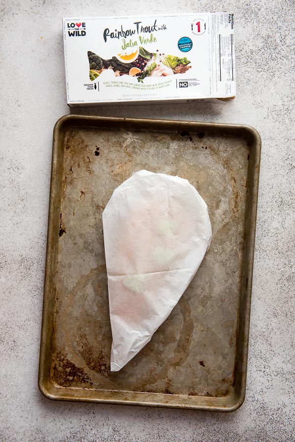 Rainbow Trout with Salsa Verde Sauce cooking in parchment paper