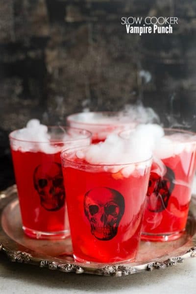 Spooky Slow Cooker Vampire Punch in skull glasses on an antique silver tray