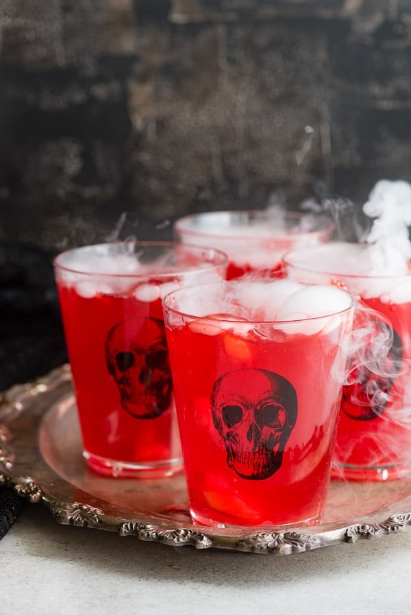 Red smoking Slow Cooker Vampire Punch on a silver tray 