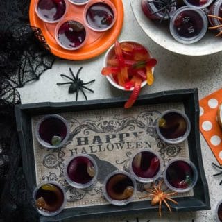 Creepy Halloween Squirm Jello Shots with gummy worms inside on a Halloween tray BoulderLocavore.com