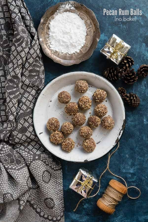 Pecan Rum Balls a no bake holiday treat (in a vintage enamel pie tin, with pine cones, powdered sugar