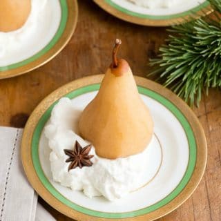 Spiced Chai Poached Pears in whipped cream on antique gold rimmed Haviland china dessert plates