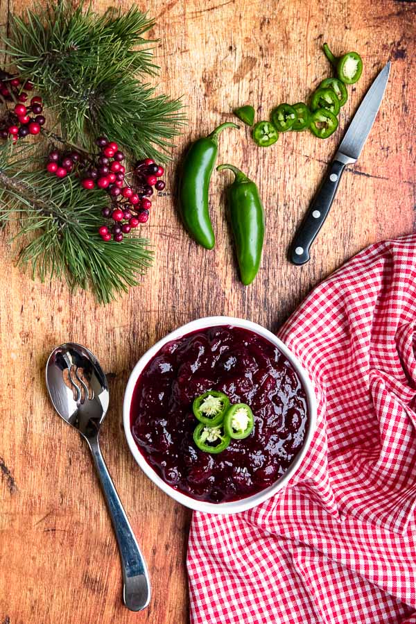Spicy Jalapeno Cranberry Sauce with chile slices in a white bowl 