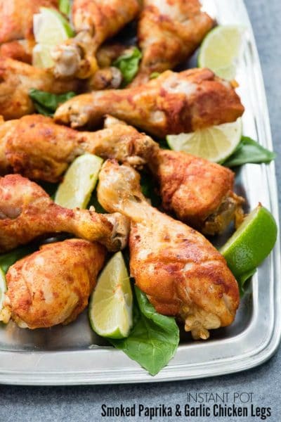 Instant Pot Smoked Paprika & Garlic Chicken Legs with lime wedges on a pewter platter