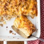 Overnight Gluten-Free English Muffin Breakfast Casserole - single slice in white baking dish