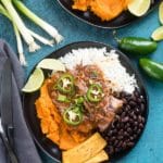 Slow Cooker Caribbean Pot Roast with sweet potatoes, rice, black beans and plantains on a black plate with deep ocean blue surface BoulderLocavore.com